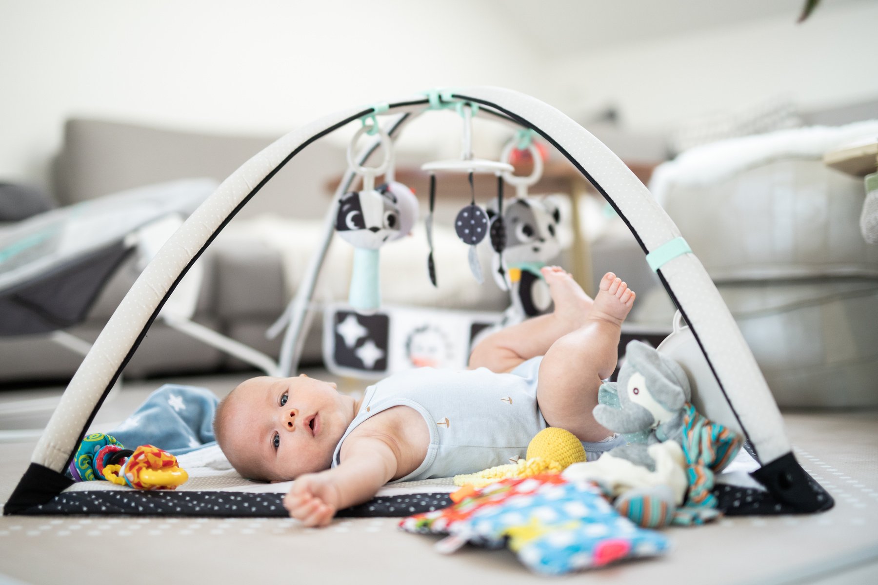 Cute Baby Boy Playing with Hanging Toys Arch on Mat at Home Baby Activity and Play Center for Early Infant Development. Baby Playing at Home